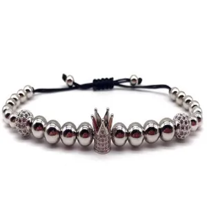 Close up of crown bead macrame bracelet details, cubic zirconia charm and metal beads.