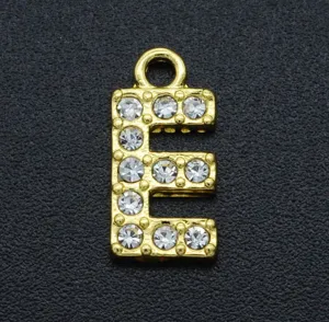 Gold plated alloy rhinestone letter E charm detail close up view, DIY jewelry part.