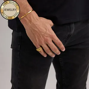 Men's minimalist gold stainless steel open cuff bracelet and ribbed ring on model