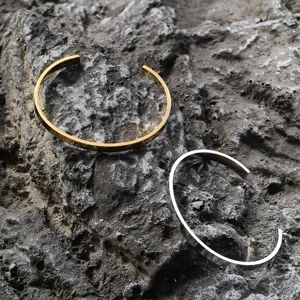 Detail showing gold and silver minimalist stainless steel open cuff bracelets for men