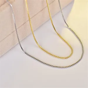 Detailed close-up showing minimalist titanium steel box chain necklaces in gold and silver