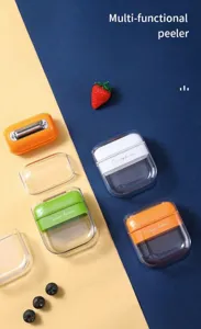 Portable multi-functional fruit peeler with clear cover, stainless steel blade, compact design.