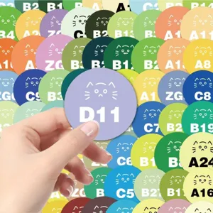 Close-up detail of round perler bead color card sticker with pixel cat face and code.