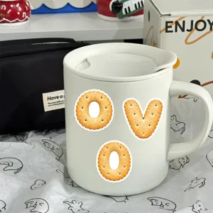 Creative Korean ins style biscuit letter stickers on white ceramic mug, cute desk decor.