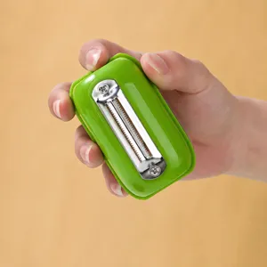 Portable fruit vegetable peeler with stainless steel blade, compact green handheld potato kitchen tool.