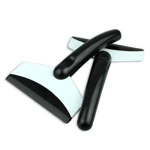 Detail view of durable black car ice scraper and snow shovel tools for clearing glass windows.