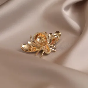 Detailed back view of the vintage gold-tone bee brooch showing sturdy pin closure and fine texture.