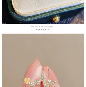 Close up of sparkling crystal ECG heartbeat brooch with cute gold heart pin for sweaters.