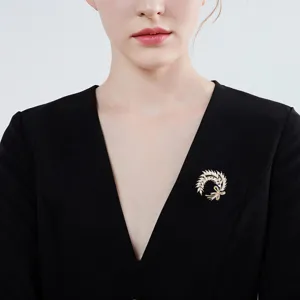 Exquisite wheat ear brooch detail shot, sparkling crystal rhinestones on polished gold metal.