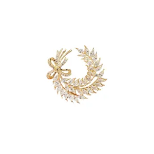 Elegant crystal wheat ear brooch for women, sparkling cubic zirconia bow pin, gold tone.