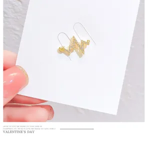 Delicate crystal ECG heartbeat brooch pin, stylish gold-tone sweater collar accessory detail.