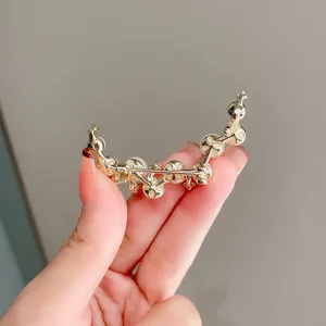 Elegant pearl crescent brooch for women, minimalist gold suit corsage and pin accessory.