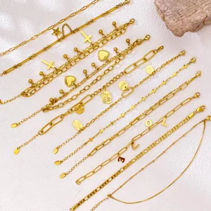 Detail view of gold-plated stainless steel bracelets featuring heart and smiley face charms