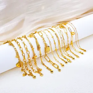 Detailed macro view of 18K gold PVD plated stainless steel chain bracelets with charms.