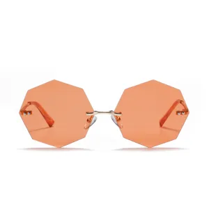 Retro rimless octagonal sunglasses for women with orange tinted lenses and gold metal arms