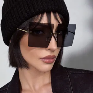 Close-up detail of stylish rimless square sunglasses on a model wearing a black beanie