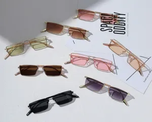 Detailed view of trendy small rectangular metal frame sunglasses with gradient lenses.