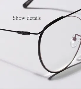 Macro view detail of vintage black metal round glasses frame and temple hinge structure