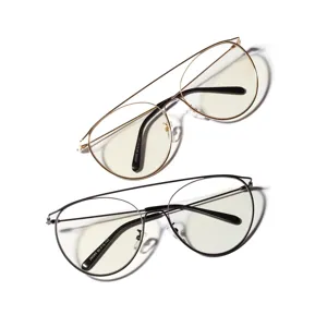 Vintage oversized metal aviator glasses in gold and black frames on white background