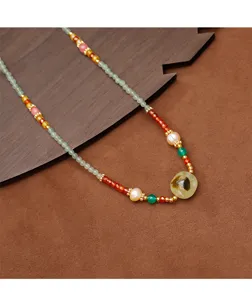 Handmade beaded necklace detail featuring prehnite pendant and freshwater pearls