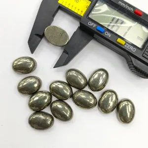 Detailed view of polished natural pyrite cabochons measured with digital caliper