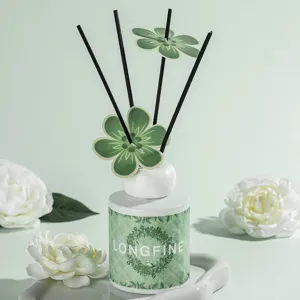 Elegant reed diffuser with green floral sticks and ceramic bottle for home bedroom decor.