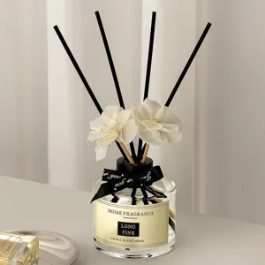 Nordic style reed diffuser set for home interior room fragrance with black sticks and white flowers.