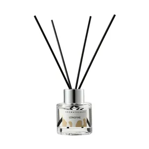 Clear glass reed diffuser set with gold drip pattern label and five black aromatherapy sticks