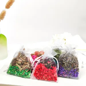 Colorful mesh sachet bags filled with aromatic dried flowers and plant botanical granules.