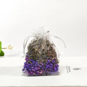 Detail view of a white mesh sachet bag filled with aromatic dried lavender and plant particles.