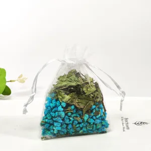 Organza sachet bag with dried flowers and blue plant particles for car and wardrobe aromatherapy.