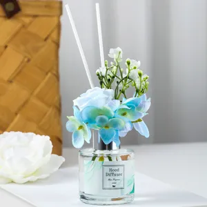 Reed diffuser set with blue artificial flowers and white sticks for home room fragrance decor