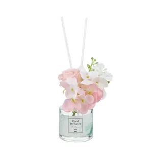 Decorative flameless reed diffuser with artificial floral arrangement for home use.