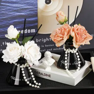Artificial rose aroma diffuser vase with black ceramic bottle and pearls for home decor.