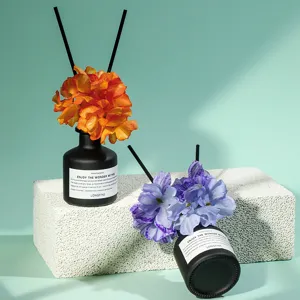 Nordic reed diffuser set with black glass bottle, artificial flowers and fragrance sticks for home decor.