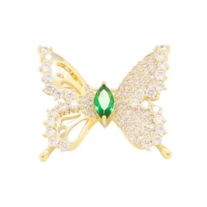 Exquisite butterfly brooch detail, sparkling clear zircons and green center stone design.