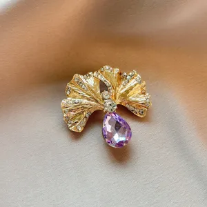 Exquisite ginkgo leaf brooch featuring sparkling rhinestones and a purple teardrop crystal accent.