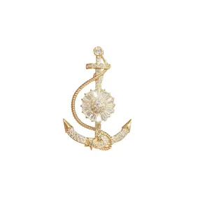Close-up of the exquisite anchor brooch, featuring sparkling zircon crystals and gold finish.