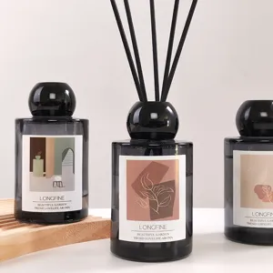 Minimalist black glass reed diffuser set with aesthetic art illustration label for home decor.
