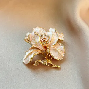 Exquisite enamel flower brooch with sparkling rhinestones and pearl details for vintage style.