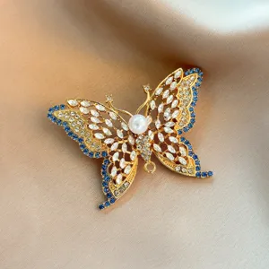 Vintage hollow crystal rhinestone butterfly brooch, elegant detail shot for women coats.