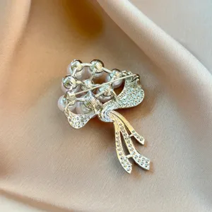 Detailed view of the rhinestone pearl brooch back pin mechanism, elegant accessory craft.