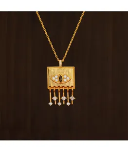 Detailed macro view of a gold-plated square pendant necklace with an evil eye zircon design