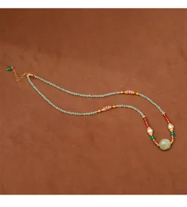 Detailed view of handmade beaded necklace with freshwater pearls and green prehnite stone.