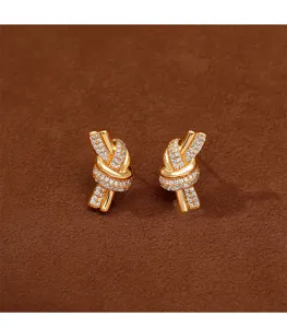 Elegant gold-plated knot stud earrings pavé-set with sparkling cubic zirconia crystals.