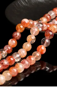 Detailed view of natural red glue flower quartz beads showing vivid internal inclusions