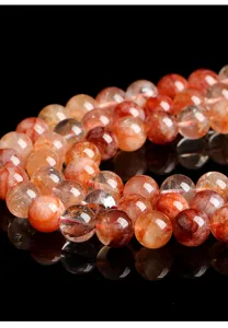 Detailed view of natural red fire quartz crystal loose beads for jewelry making.