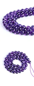 Macro detail of natural round purple amethyst beads for DIY jewelry making accessories.