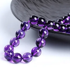 Natural purple amethyst round beads for DIY jewelry making on black plate