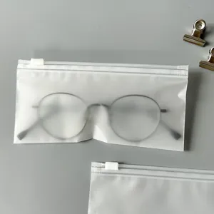 Detail view of frosted zipper storage bag with clear texture on gray background for portable use.